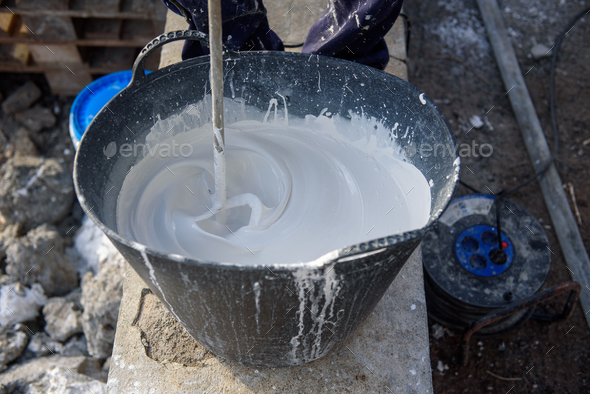 Worker Mixing Plaster In Bucket Stock Photo By Gabistock Photodune